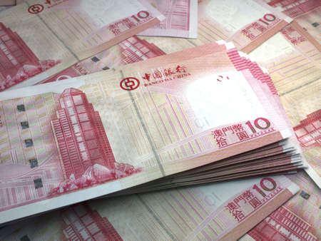 Money of Macao. Macanese pataca bills. MOP banknotes. 10 patacas. Business, finance, news background.の写真素材