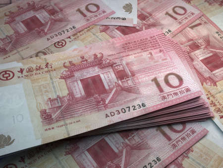 Money of Macao. Macanese pataca bills. MOP banknotes. 10 patacas. Business, finance, news background.の写真素材