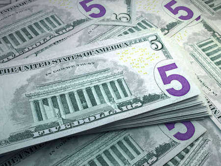 Money of United States. United States dollar bills. USD banknotes. 5 dollars. Business, finance, news background.の写真素材