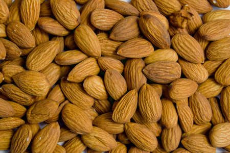 almonds close-up. nuts lie on a plane