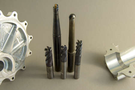cutters for metal processing. worn out cutting tool. nearby are the aluminum parts made by this...