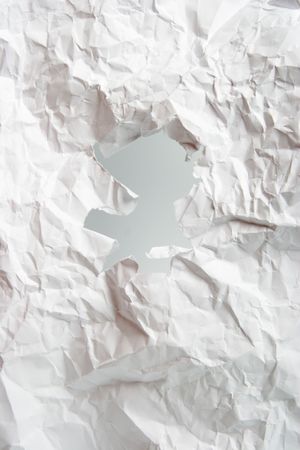 Hole in a crushed paperの写真素材