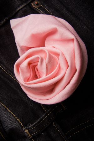 Red rose from a fabric in a pocket of jeansの写真素材