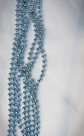 beads on a light blue background with space for text.の写真素材