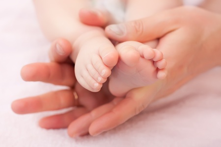 Baby's feet in daddy's handsの写真素材