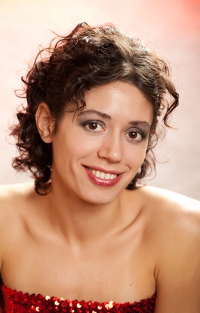 portrait of the young dark-haired girl in studio on color backgroundの写真素材