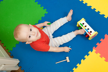 baby plays in a nurseryの写真素材