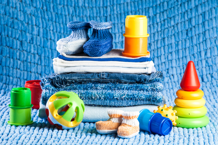 knitted clothes for newborn, stacked, lying on the tableの写真素材