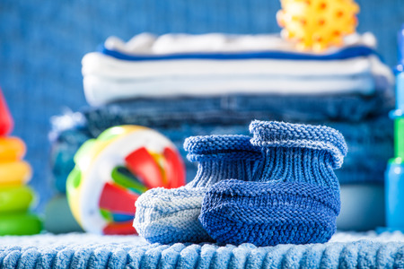 knitted clothes for newborn, stacked, lying on the tableの写真素材