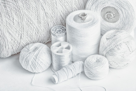 cotton thread for sewing, wound on a wooden spool, vintage, on white backgroundの写真素材