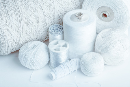 cotton thread for sewing, wound on a wooden spool, vintage, on white backgroundの写真素材