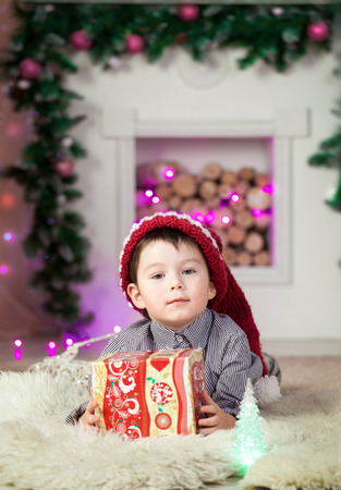boy sitting on a chair in the room, painted for Christmasの写真素材