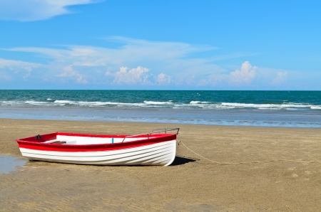 boat on a beach with a bright blue skyの写真素材