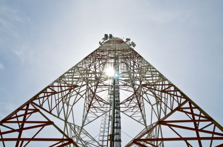 communications tower with antennas against blue skyの写真素材