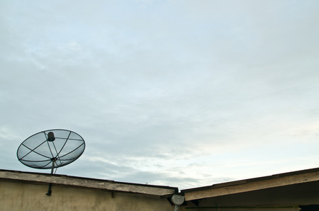 satellite dish on the roof, sky background