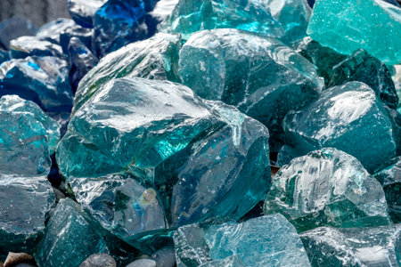 A closeup shot of a pile of blue pieces of broken glass