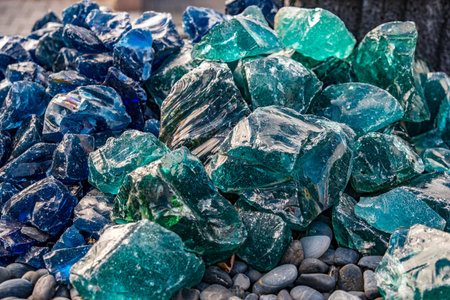A pile of broken glass on a pebble beach.の写真素材