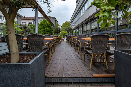 A girl in a red dress sits on a stone staircase, smiling at the sun. It's a moment of summer serenity.の写真素材