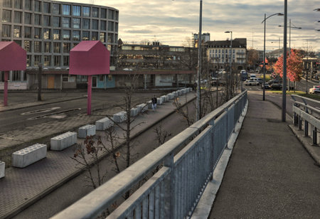Urban Train Tracks At Sunset Overlooking Station And Pedestrian Bridge With Empty Platform, Concrete...