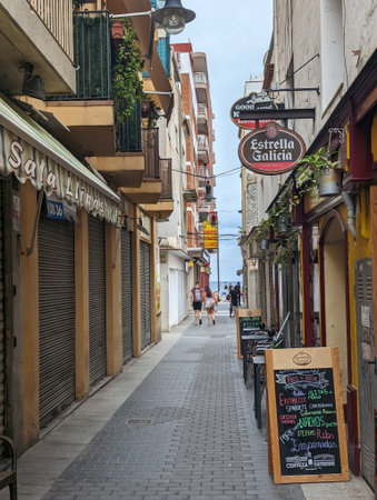 Pforzheim, Germany, Dezember , Narrow Cobblestone Alley Lined Shops, Server Updating Chalkboard Menuのeditorial素材