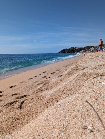 Pforzheim, Germany, Dezember , Sandy Beach With Ocean Waves And Scattered Footprints, Pebblesのeditorial素材