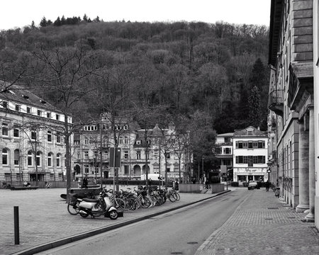 Heidelberg Germany January 24, 2026 Empty European Street With Parked Scooters And Bicycles, Historic Facades Lining Cobblestone Plaza, Hillside Backdrop With Overcast Sky, Quiet Premarket Heidelberg Germany January ,のeditorial素材