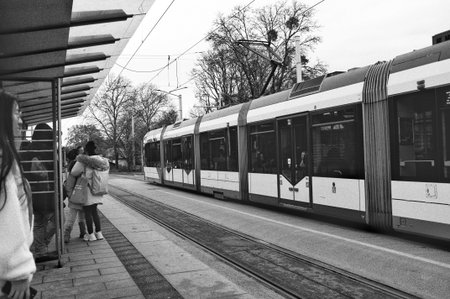 Heidelberg Germany January 24, 2026 Wet Tram Platform Commuters Under Umbrellas, Monochrome City...