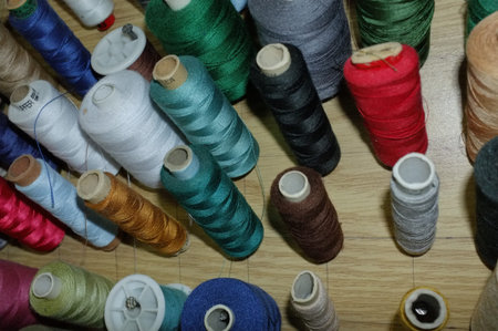 Vertical Spools On Wooden Board, Organized Rows Of Colorful Thread Pegs, Dense Stock For Sewing Or...
