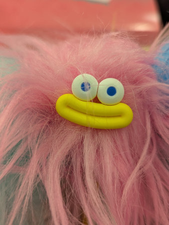 Pink Shaggy Character With Yellow Smile, Playful Closeup Revealing Textured Fur And Expressive Eyes...