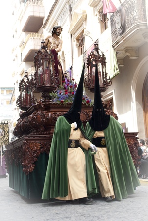 Couple of penitents with a Holy Week image during a procession in Jumilla  Spain のeditorial素材
