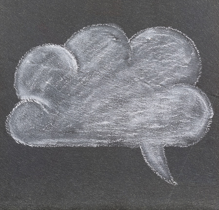 A speech bubble, drawn with white chalk on a plate of slate の写真素材