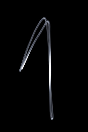 Illuminated number one on a black backgroundの写真素材