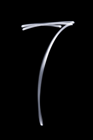 Illuminated number seven on a black background