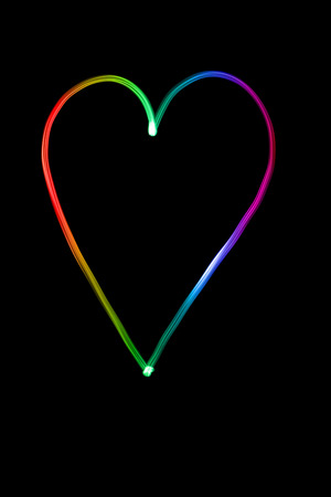 Illuminated heart made out of light in many different colorsの写真素材