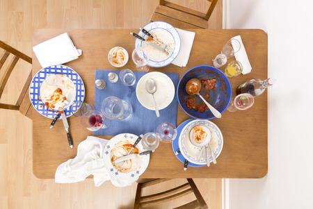 Table with chairs and dirty dishes Arranged on it