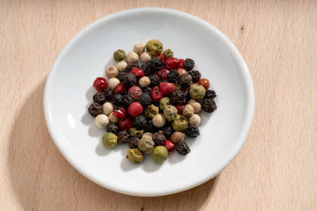 Detailed and large close up shot of peppercorns on a small plateの写真素材