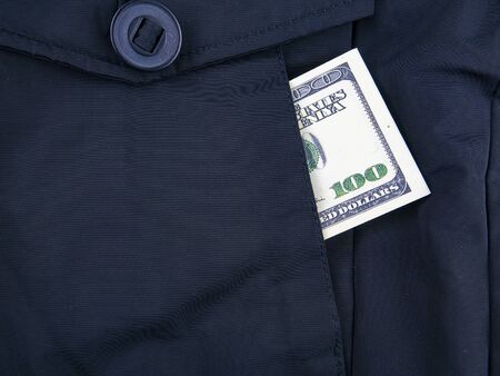 Money dollars in a jacket pocket. Place for text.