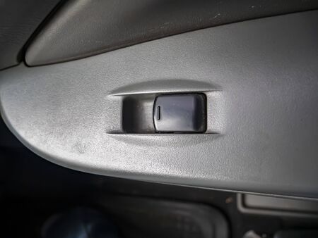 Power window button of a car. Place for text. Transport.