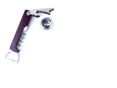 Beer bottle cap and bottle opener on a white background. Place for text.の写真素材