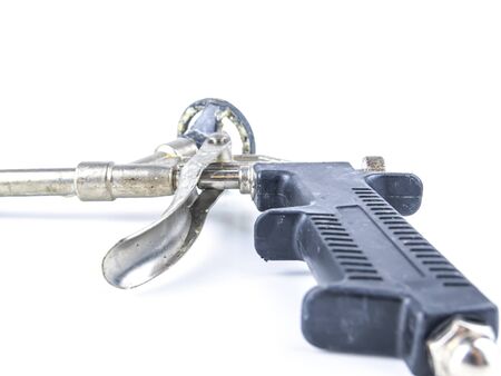 Construction tool gun for mounting foam. Place for text.