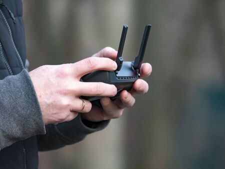 The quadrocopter control panel in the hands of a man. Dron.Technology. Place for text. Background...