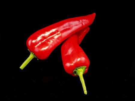 Red pepper on a black background with place for text. Food photo. Free place.の写真素材