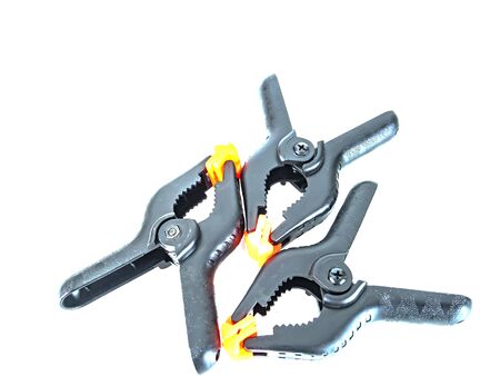 Construction tool black plastic clothespin on a white background. Place for text.の写真素材