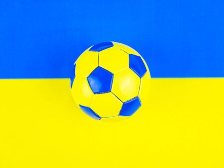 Soccer ball on the background of the national flag of Ukraine. Place for text. Football championship. Europe. World. National team.の写真素材