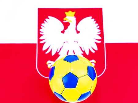 Soccer ball on the background of the flag of Poland. Championship. World. Europe. Place for text.の写真素材