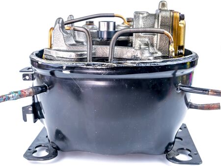Compressor for repairing refrigerators on a white background. Repair of refrigerators. Equipment. Valve. Piston. Place for text. Spare parts for the refrigerator.の写真素材