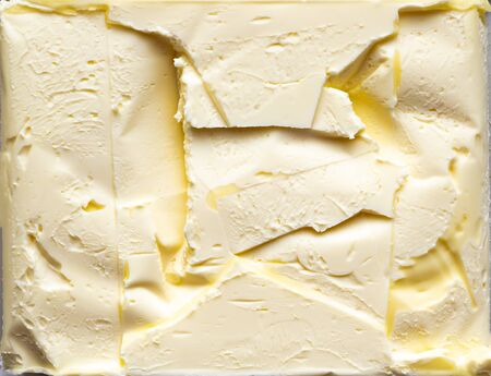 The texture of the surface of the butter with the impression of the packaging. Place for text. Template. Poster. Background image.の写真素材
