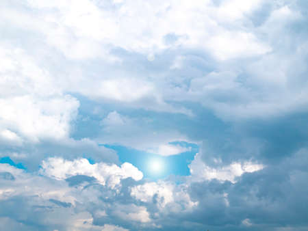 The sun on the background of the cloudy sky. Background image. Sun glare. Camera lens flare. Place...