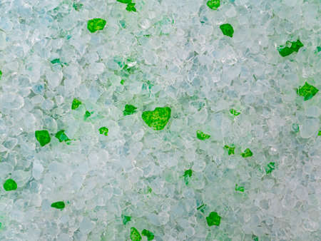 Texture of white and green crystalline granules. Background image. Template with place for text. Cat toilet.の写真素材