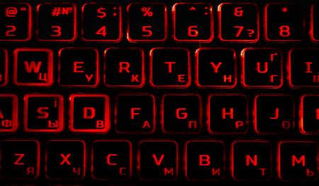 Computer keyboard in black and red colors abstract illustration. Computer techologies. Typing on the keyboard. Abstract background image. Red illumination of laptop buttons.の写真素材